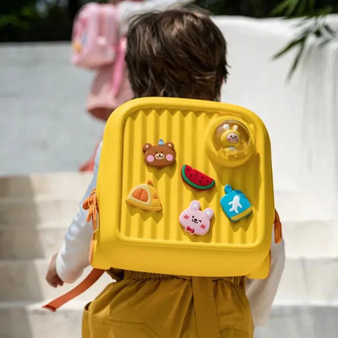garçon cartable jaune de dos