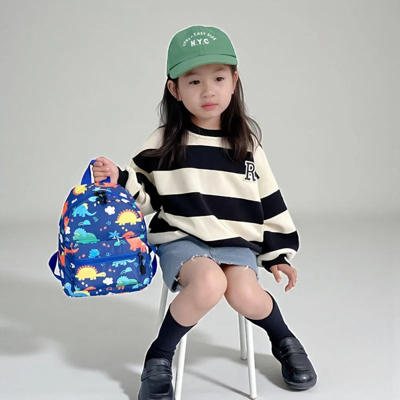 SAC DINO BEBE BLEU MANNEQUIN FILLE ASSISE