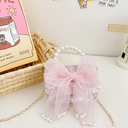 Sac a main enfant fille Rose Perle posé sur une table