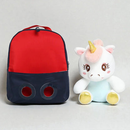 Sac à dos licorne bébé avec peluche amovible posée à côté
